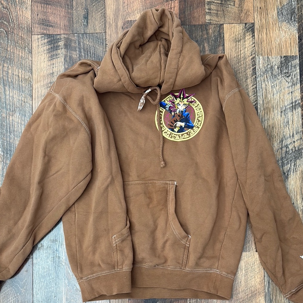 Primitive Brown Sweater with Nature-Inspired Emblem